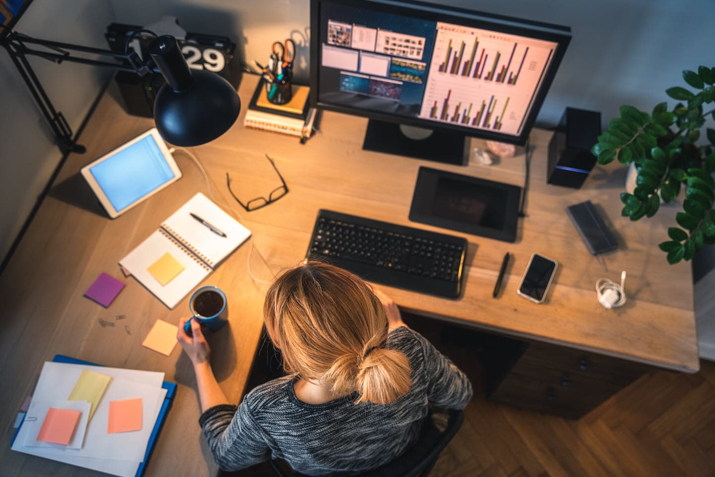 Tidy home office desk with monitor, tablet and phone